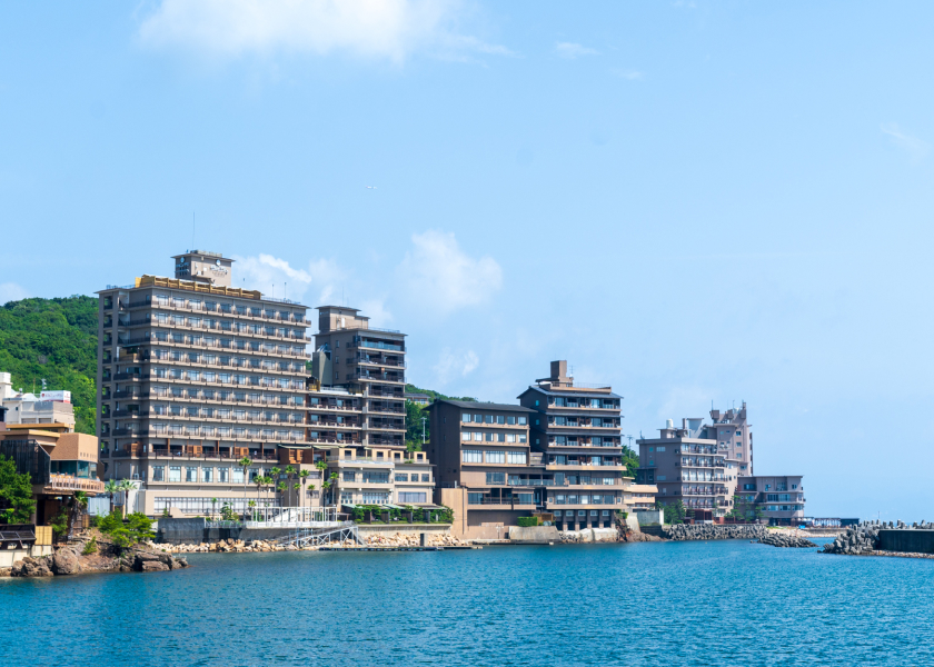 Hotel New Awaji oceanfront property exterior along the coastline, offering a classic seaside ryokan stay experience