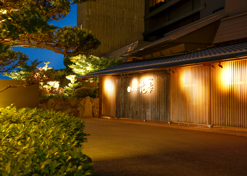 Nagisa no Sho Hanagoyomi traditional exterior with warm lighting and landscaped garden, creating an intimate and tranquil ryokan atmosphere