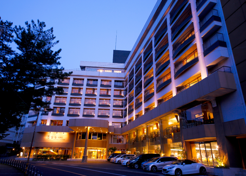 Yumekaiyu Awajishima large resort exterior with evening lighting, offering a comfortable and accessible oceanfront stay
