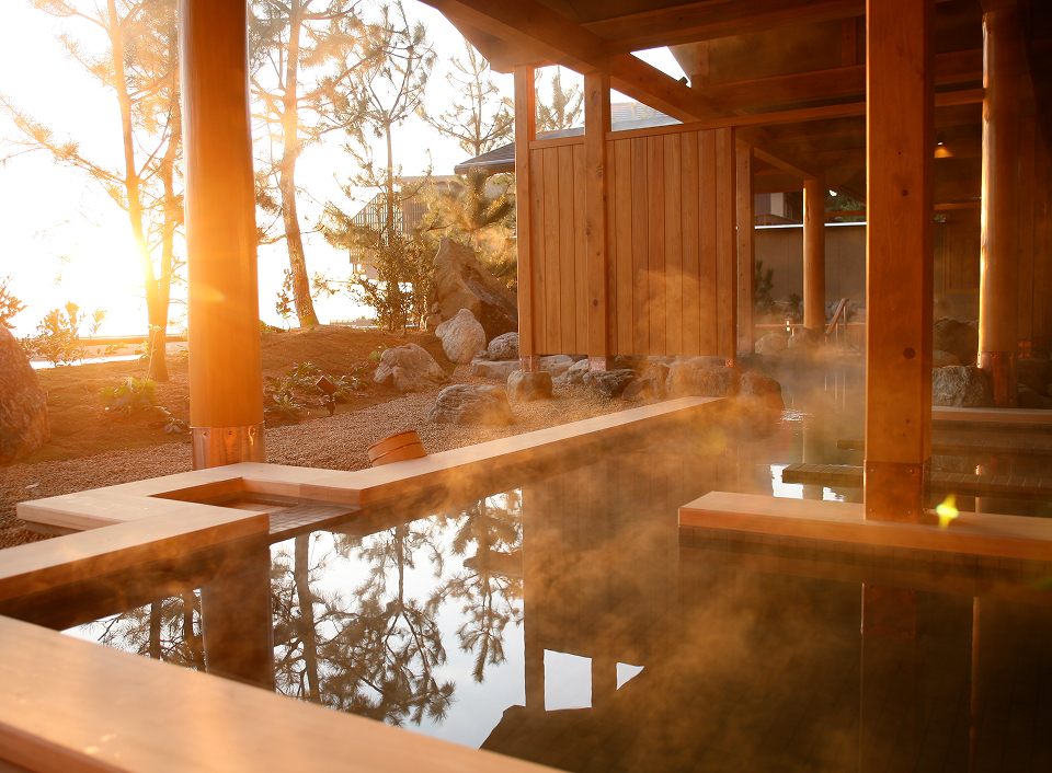 Hotel New Awaji outdoor onsen with natural wood and garden setting, providing a relaxing wellness experience immersed in nature