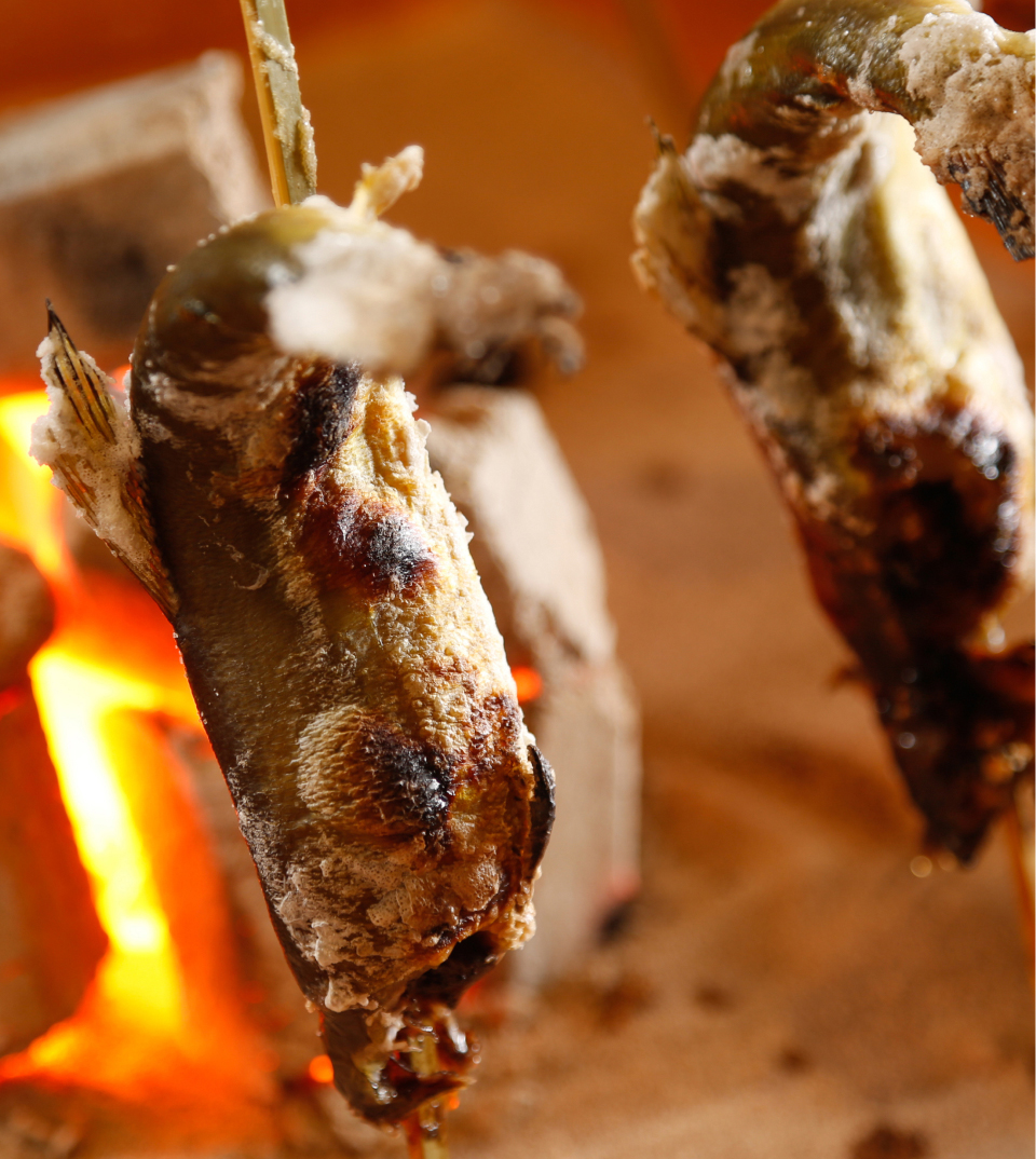 Grilled fish prepared over open flame as part of traditional Japanese cuisine on Awaji Island