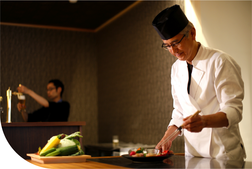 Japanese chef plating seasonal dish at a restaurant on Awaji Island in Japan