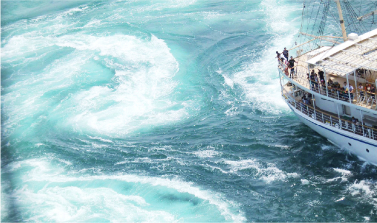 Boat moving through swirling coastal waters near Awaji Island, offering an active ocean experience easily reached from Hotel New Awaji properties