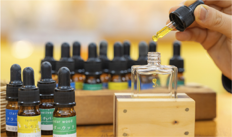 Hands blending fragrance oils at an Awaji workshop, offering a personalized cultural experience rooted in the island's incense heritage