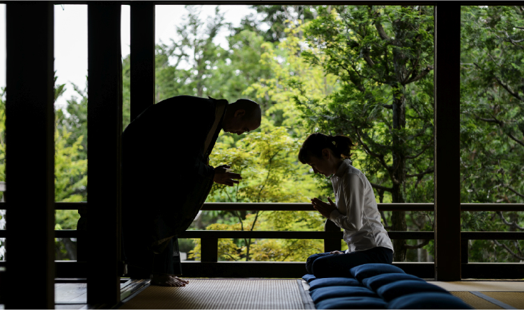Monk guiding seated meditation inside a Kyoto temple, offering a quiet and reflective Zen practice experience