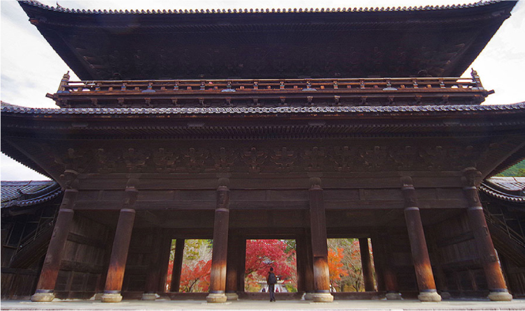 Large wooden temple gate and brick aqueduct at Nanzenji in Kyoto, blending traditional architecture with historic infrastructure