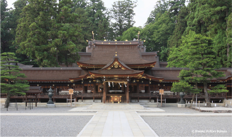 Traditional shrine surrounded by forest near Lake Biwa, offering a peaceful visit rooted in local spiritual heritage