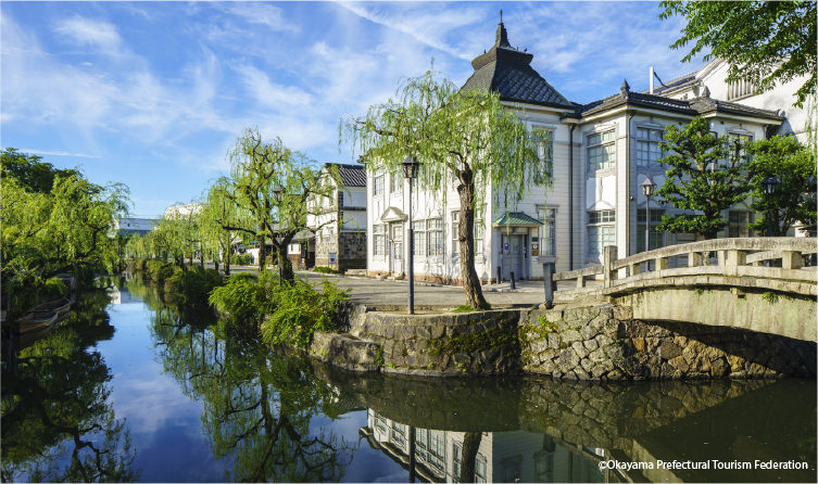 Canal-lined street with preserved white-walled buildings in Kurashiki, offering a picturesque walk through historic merchant town culture