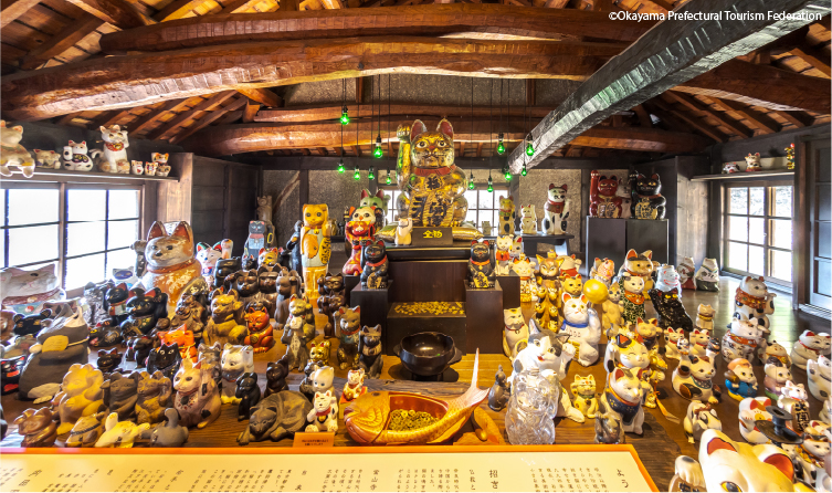 Interior filled with maneki-neko figurines, offering a playful and artistic cultural experience unique to Okayama