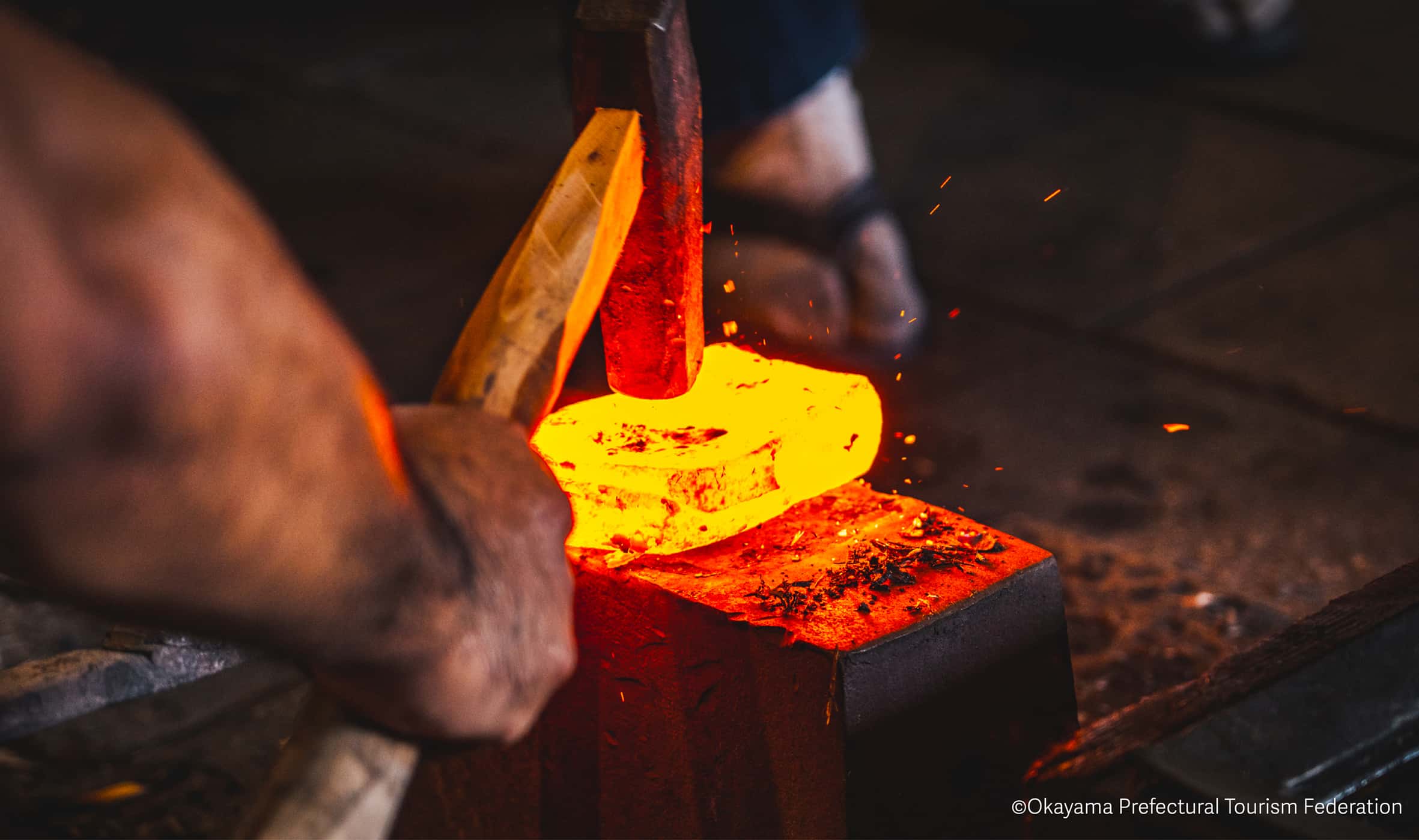 Japanese blacksmith forging metal with traditional techniques, hands-on cultural craft experience in Japan