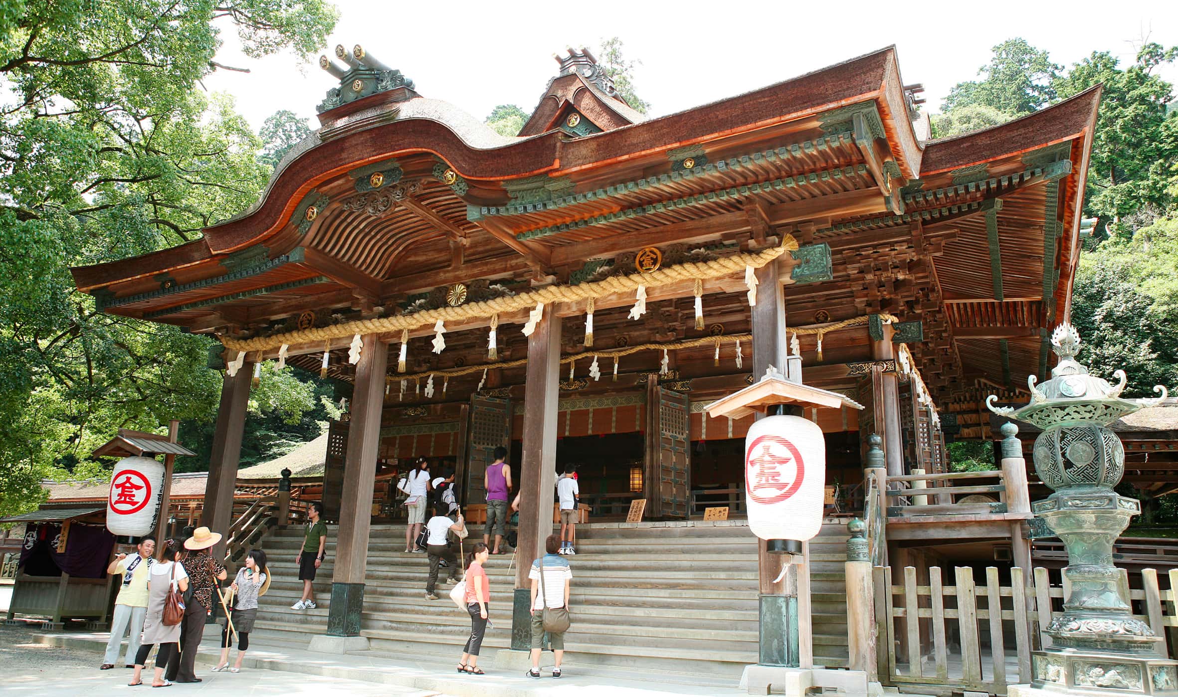 Historic Japanese shrine with visitors and traditional architecture, cultural sightseeing experience in Japan