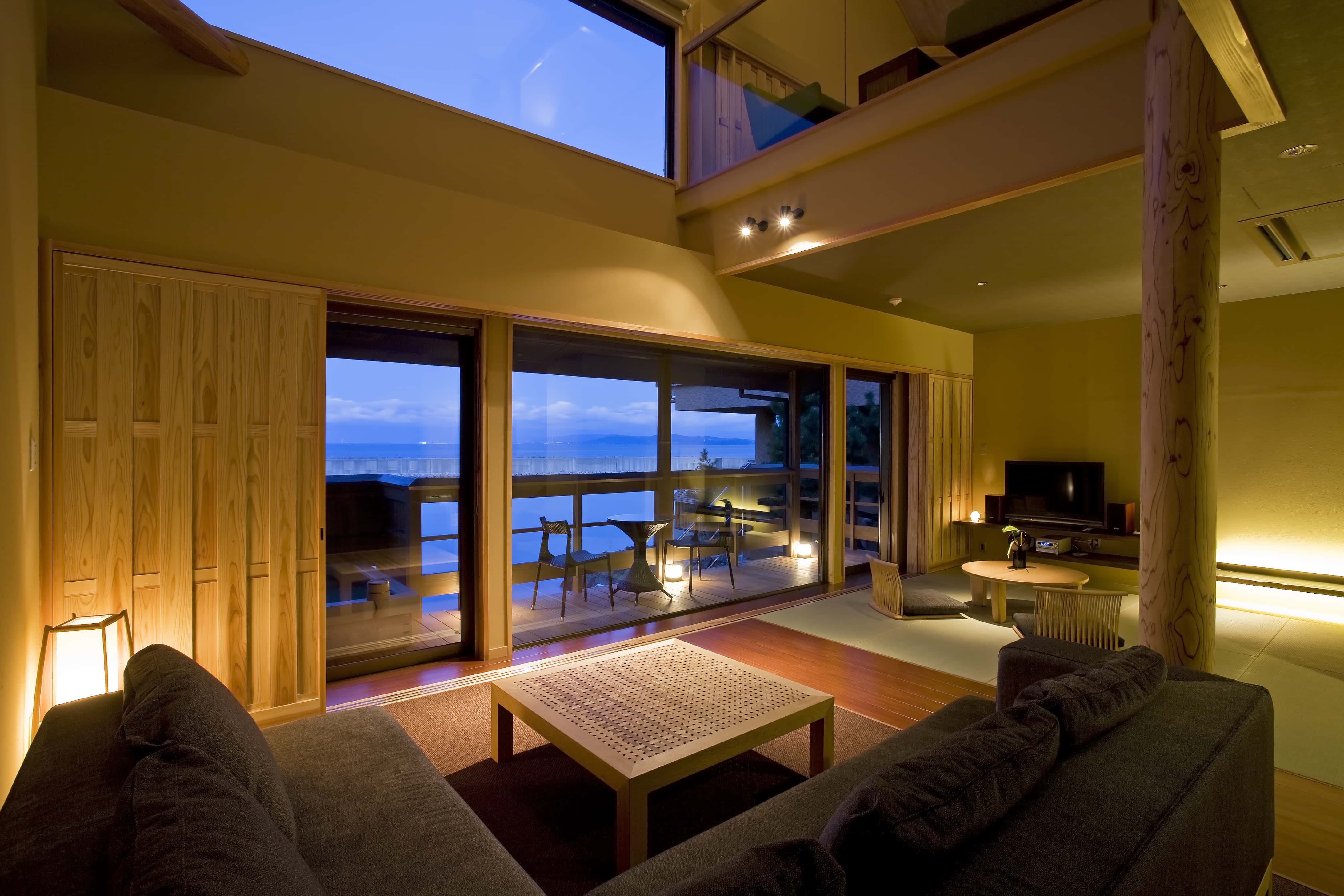 Spacious suite with ocean view terrace and warm wood interiors at Hotel New Awaji, Awaji Island
