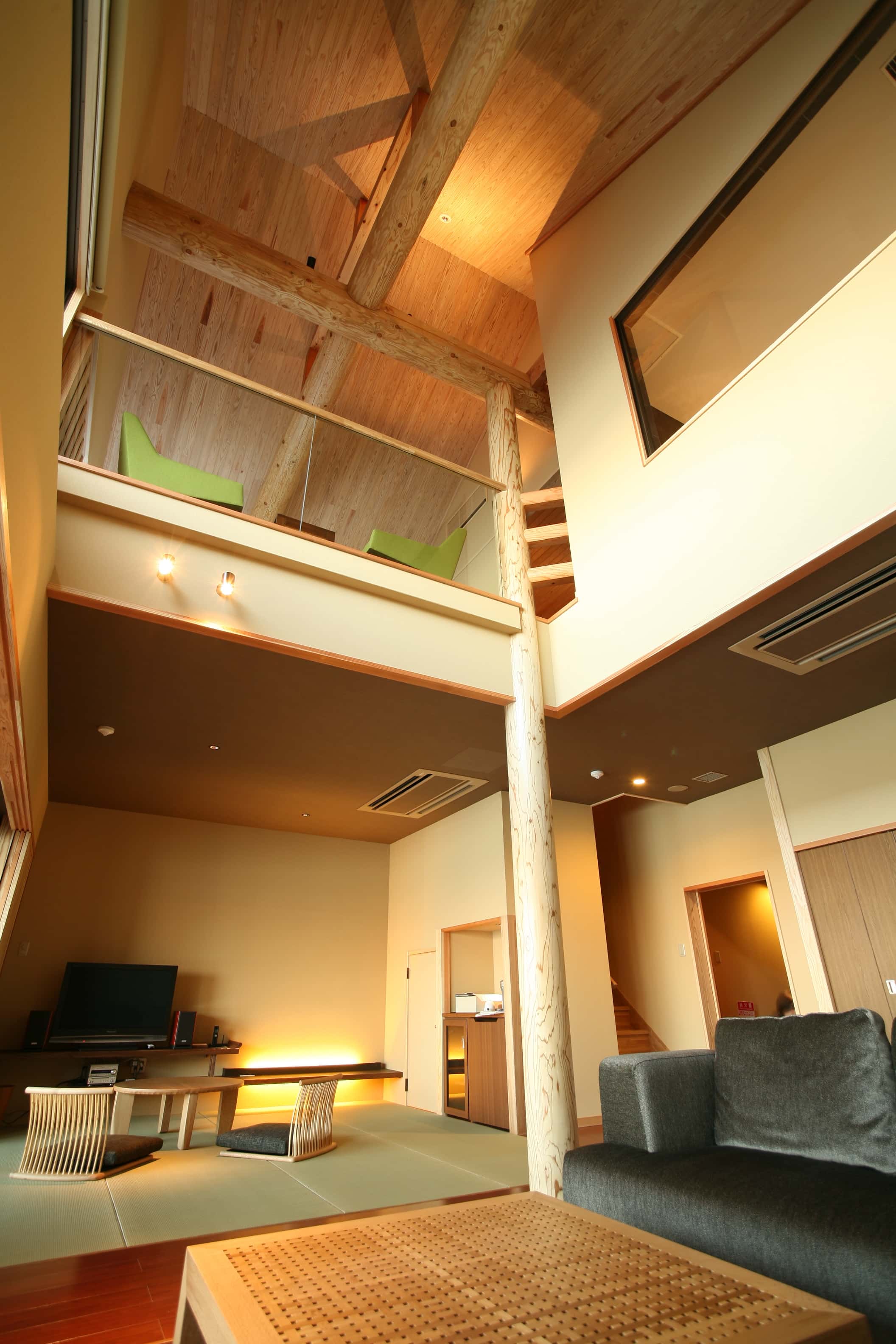 Two-story Japanese-style suite with exposed wood beams and open living space at Hotel New Awaji, Awaji Island