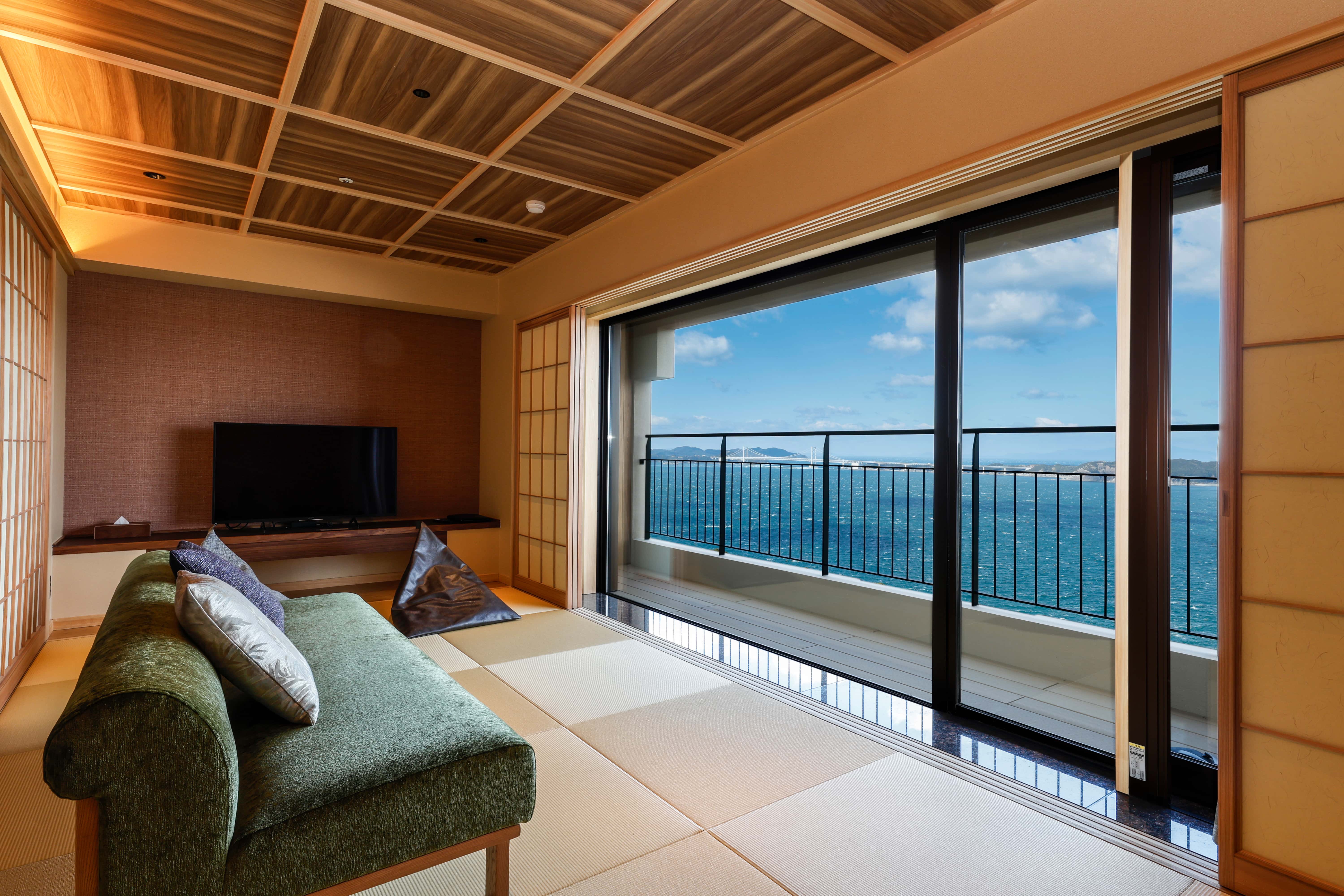 Private outdoor terrace with seating and ocean view from guest room on Awaji Island, Japan