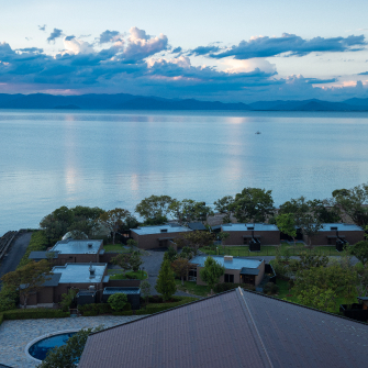 Lake Biwa shoreline with waterfront villas and mountain backdrop, offering a calm and expansive lakeside retreat