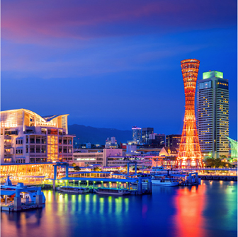 Kobe harbor skyline at night with illuminated tower and waterfront, showcasing a vibrant and modern city atmosphere