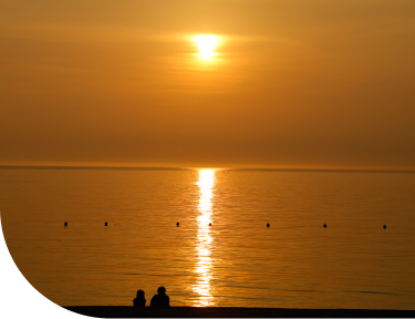 Awaji Island sunset over calm ocean with golden reflections, evoking a peaceful coastal escape near Osaka and Kobe