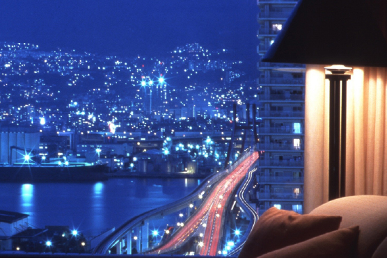 Kobe city lights spreading across the urban landscape at night, revealing the scale and energy of one of Japan's most cosmopolitan harbor cities