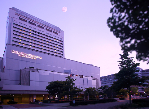 Kobe Bay Sheraton Hotel and Towers exterior at dusk, part of Hotel New Awaji Group, offering trusted global luxury with seamless access to Kobe's harbor and city