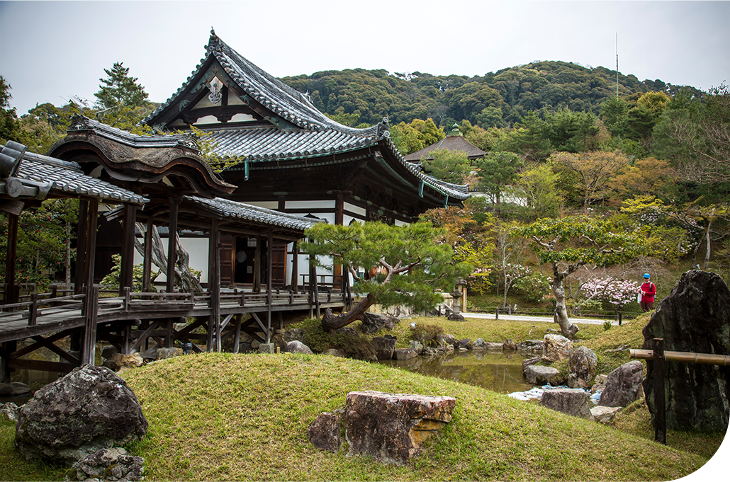 Expansive Kyoto garden with raked gravel paths, stone lanterns, and traditional temple structures, designed for reflection and quiet presence