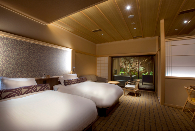 Guest room with private open-air bath at Saka-Hotel Kyoto, featuring warm wood ceilings and refined contemporary furnishings for a restful and private stay