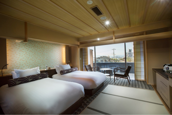 Deluxe twin room with engawa terrace at Saka-Hotel Kyoto, where a traditional veranda extends the living space and frames views of the surrounding cityscape
