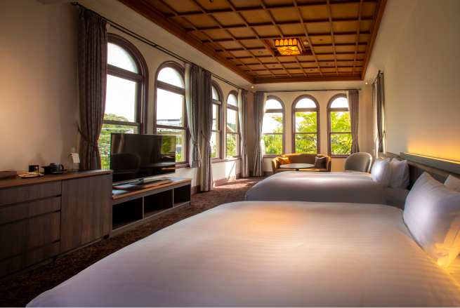 Dai dai room in the Western Building at Hotel Yuraku Kyo-yutaki, featuring arched windows, warm wood tones, and generous natural light in a refined Western-style setting