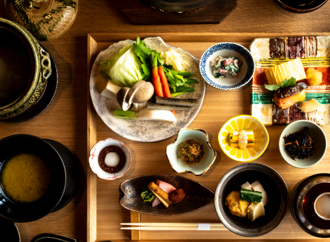 Seasonal kaiseki course presented in lacquered and ceramic vessels, reflecting Kyoto's culinary tradition and devotion to craft