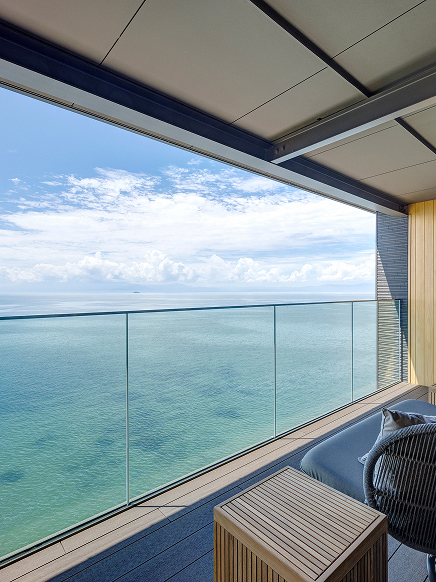 Private suite with floor-to-ceiling glass overlooking the open expanse of Lake Biwa, offering an uninterrupted connection to the water and sky