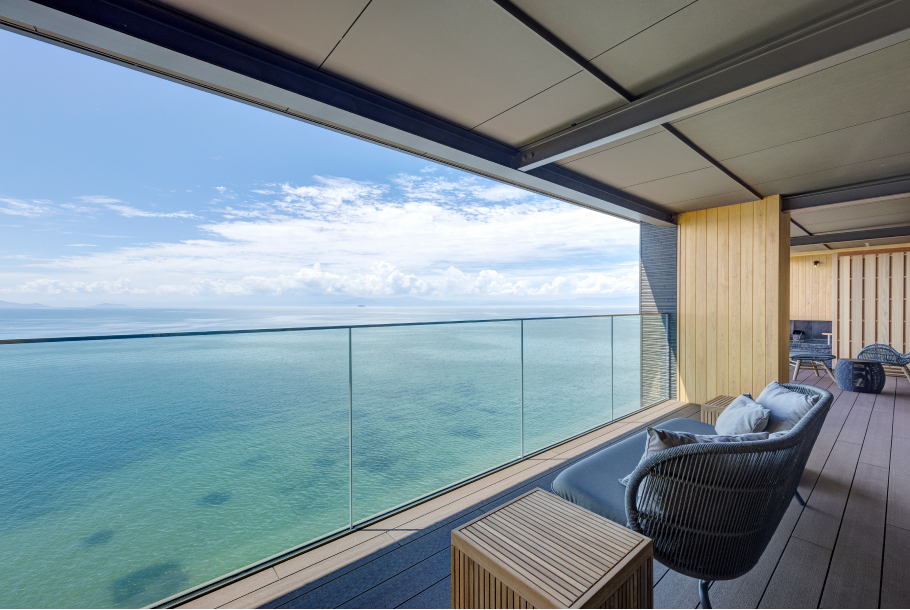 Guest room terrace with lounge seating and glass railing at Hotel New Awaji Biwa Lake in Hikone, Shiga, Japan, offering panoramic views over Lake Biwa