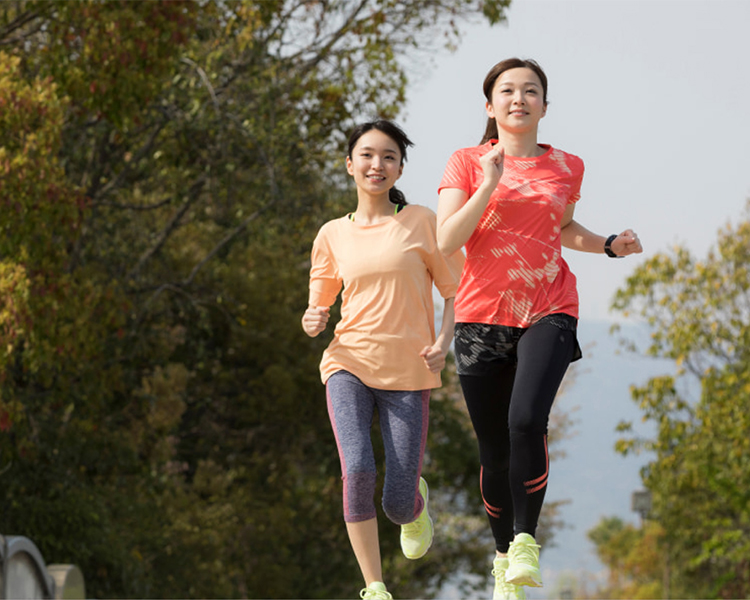 Outdoor wellness experience on Awaji Island with guests jogging through scenic natural surroundings