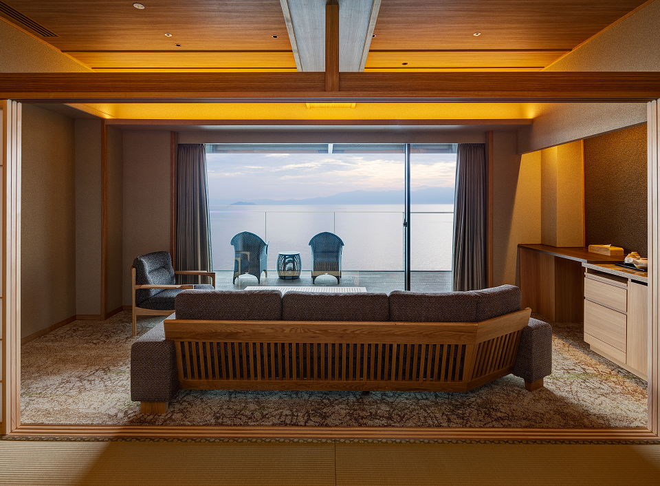 Biwafront Hikone guest suite with living area and private balcony overlooking Lake Biwa, offering a calm and scenic lakeside stay