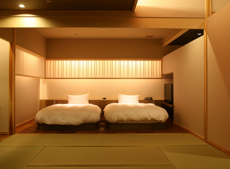 Hotel New Awaji guest room with tatami flooring and low beds, offering a calm and traditional Japanese stay experience