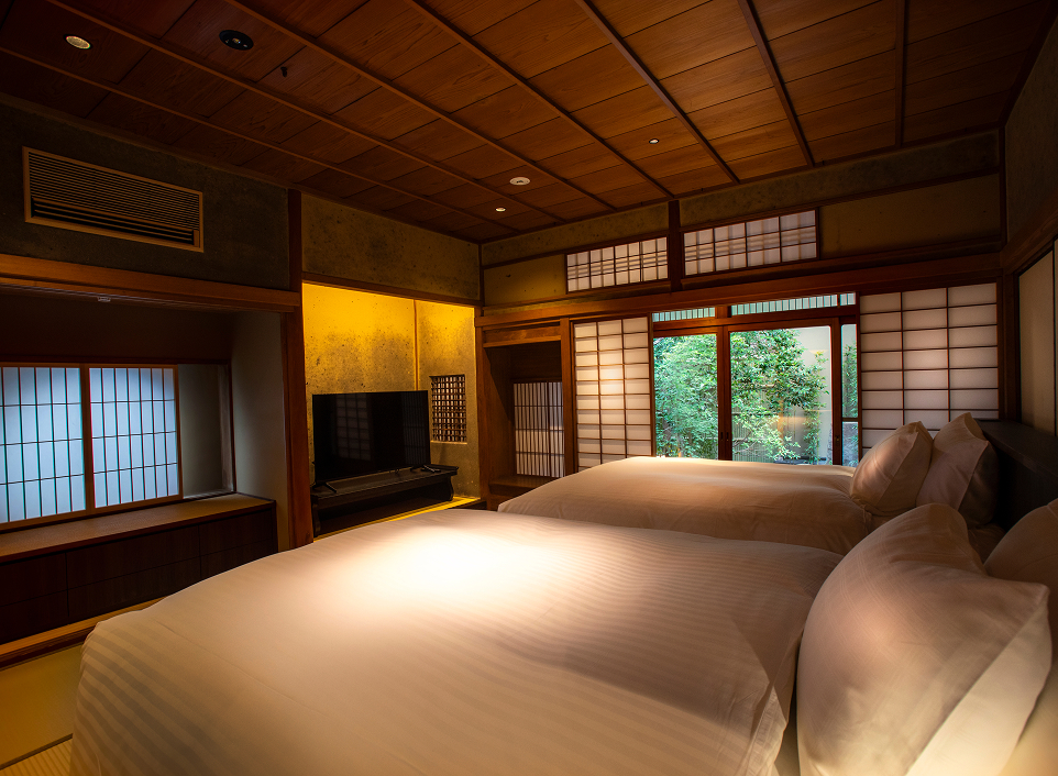 Hotel Utano Kyoto Besho guest room with soft lighting and garden views, blending modern comfort with traditional Kyoto design