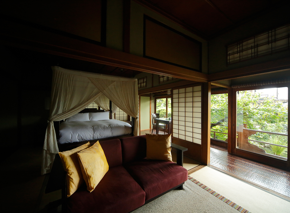 Kotohira Kadan guest room with tatami seating and garden views, blending refined traditional design with a tranquil ryokan atmosphere