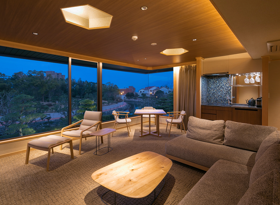 Umi no Hotel Shimahana Residence Villa living room with panoramic windows, offering a comfortable and scenic long-stay experience