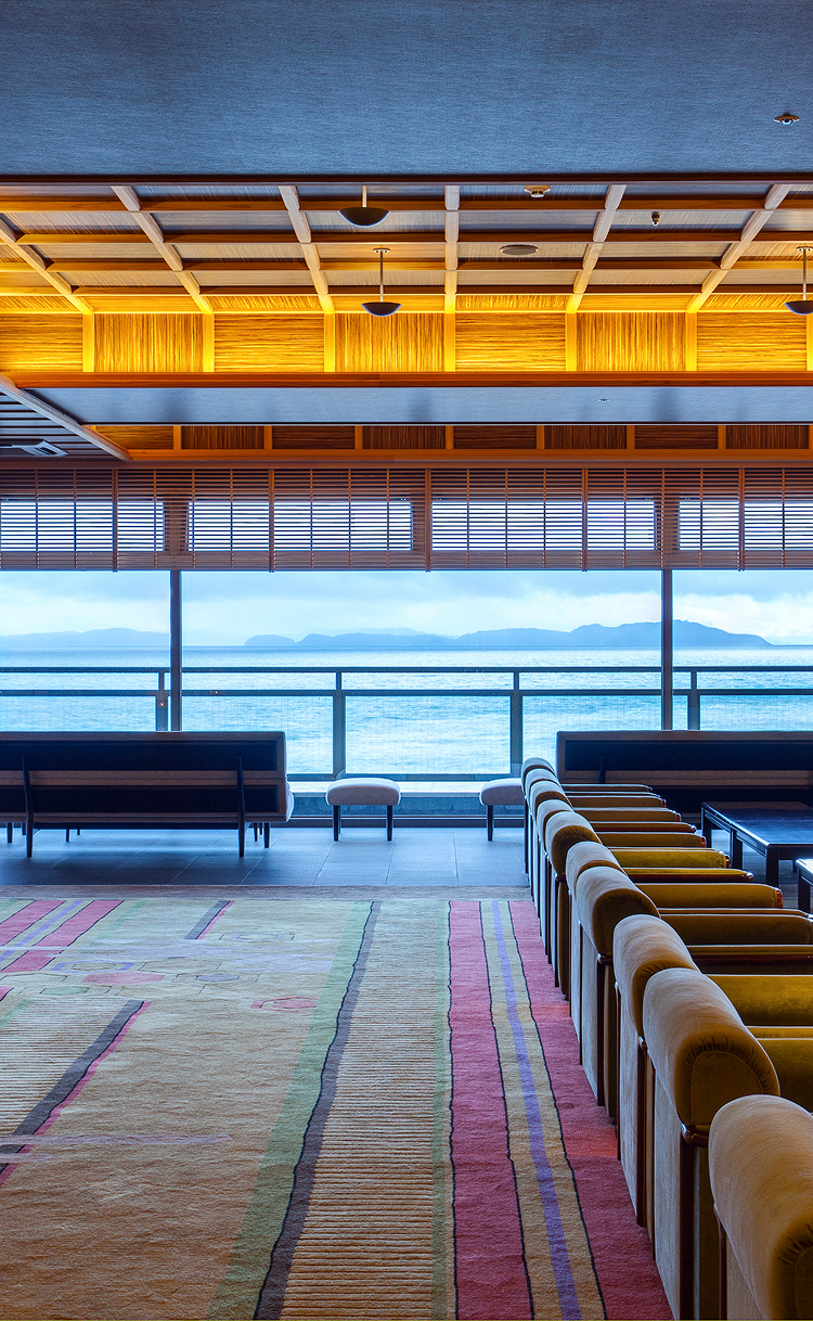 Hotel New Awaji lobby lounge with oceanfront views, showcasing warm wood interiors and a relaxing seaside atmosphere