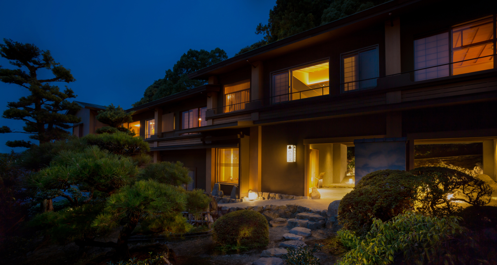 Mist-shrouded mountain valley at dusk in Shikoku, where layered forest ridgelines evoke the stillness and depth that define Hotel New Awaji Group's most secluded retreat