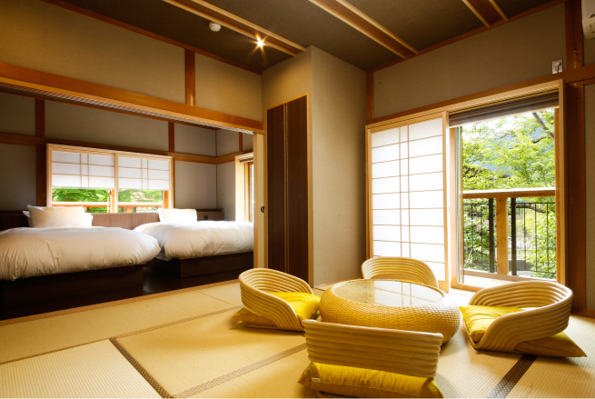 Satoyama Suite Type G at Saka-Hotel Kyoto with clean contemporary lines, accent seating, and a garden-facing window framing the natural landscape of Shikoku