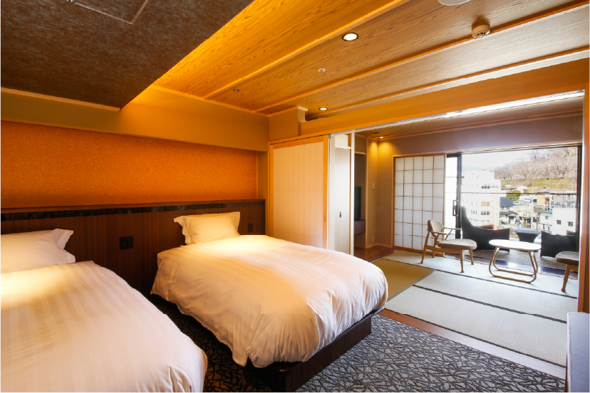 YUROU Special Floor room at Hotel Yuraku Kyo-omishima with warm amber lighting and traditional wooden detailing, offering a refined and atmospheric stay in Okayama