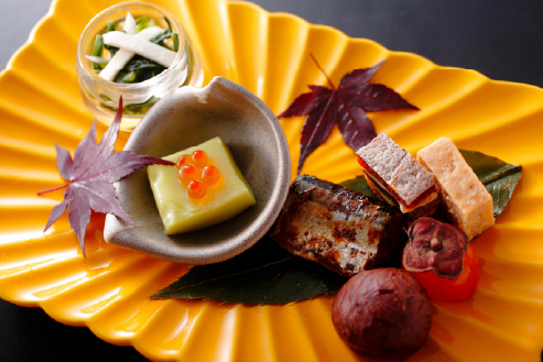Seasonal regional dishes with autumn garnish on ceramic ware, expressing the refined authenticity of Shikoku and Okayama's culinary traditions