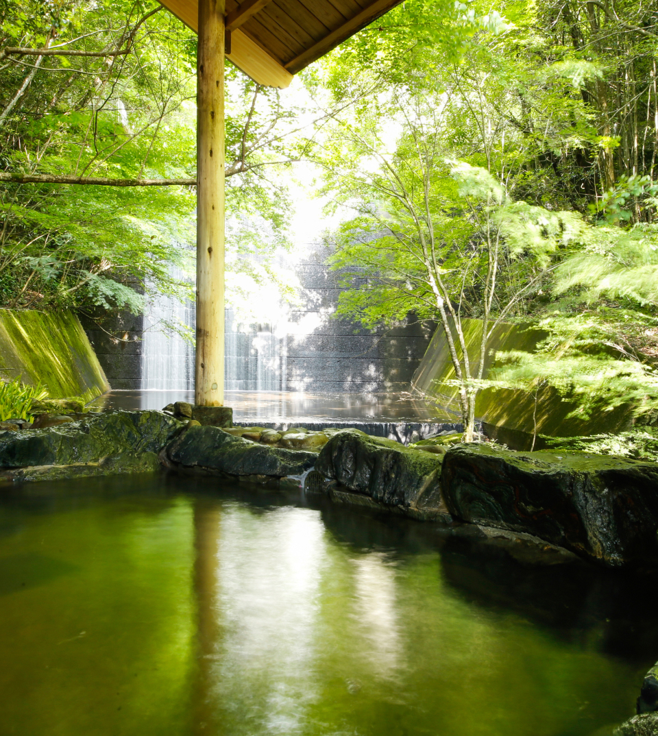 Outdoor onsen bath surrounded by nature on Awaji Island in Japan for relaxation and wellness